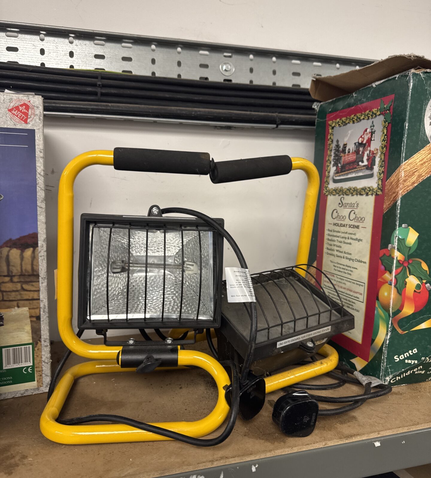 Pair of halogen site lights with metal cages for jobsite illumination.