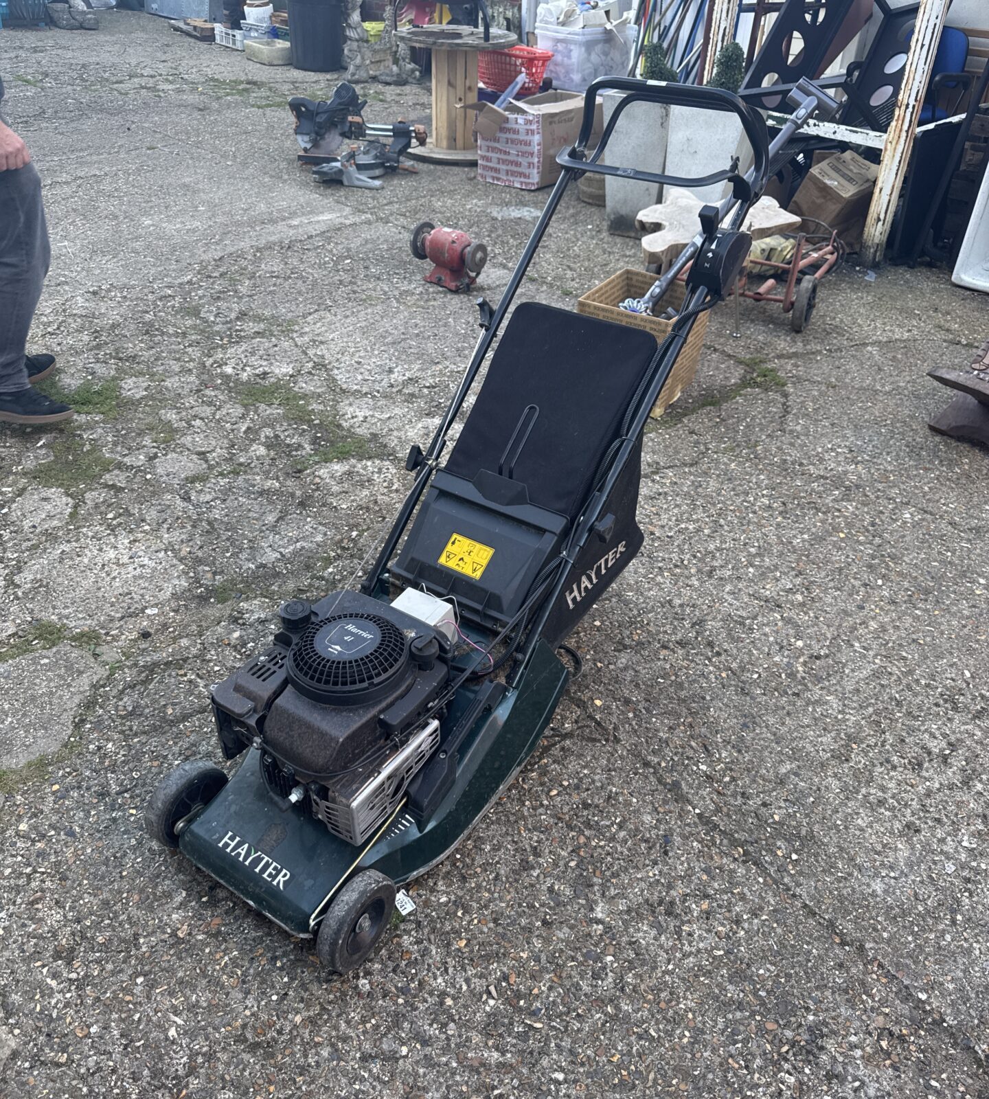 Used Hayter Harrier 41 petrol lawn mower in garden setting.