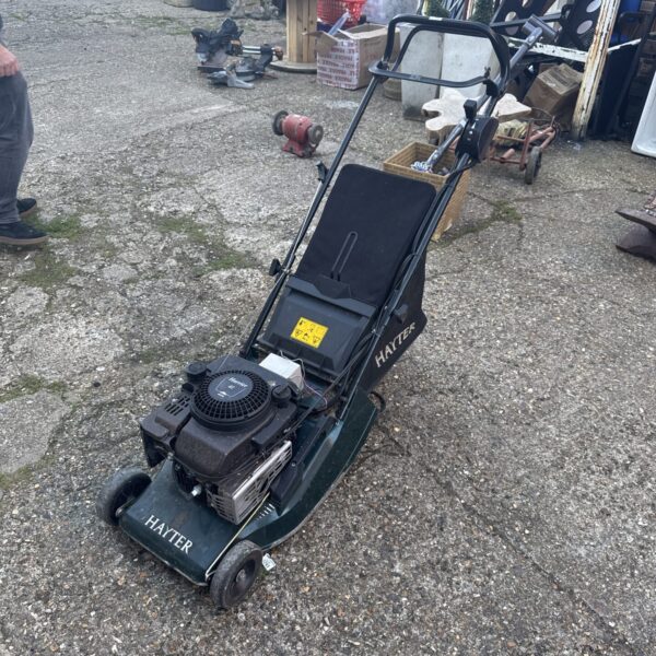 Used Hayter Harrier 41 petrol lawn mower in garden setting.