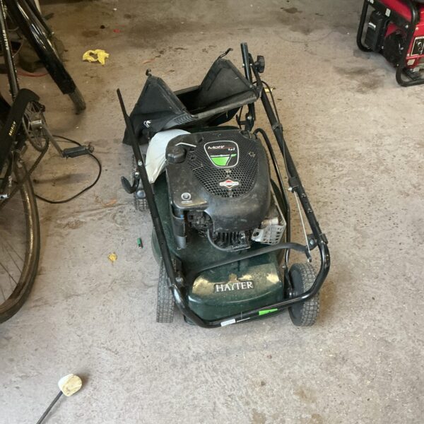 Hayter Motif 41 petrol lawnmower for repair in a garden setting.