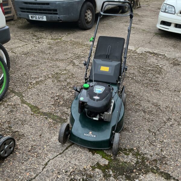 Vintage Hayter Motif 53 petrol lawnmower in a garden setting.