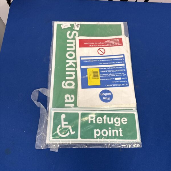 Assorted health and safety signage including fire and first aid signs.