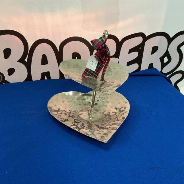 Elegant heart-shaped two-tier metal cake stand for desserts.