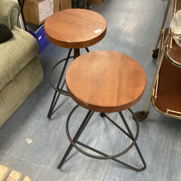 Pair of height adjustable industrial stools with wooden seats.
