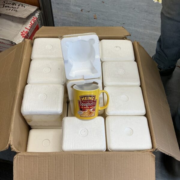 A box of vintage Heinz Spaghetti branded mugs.