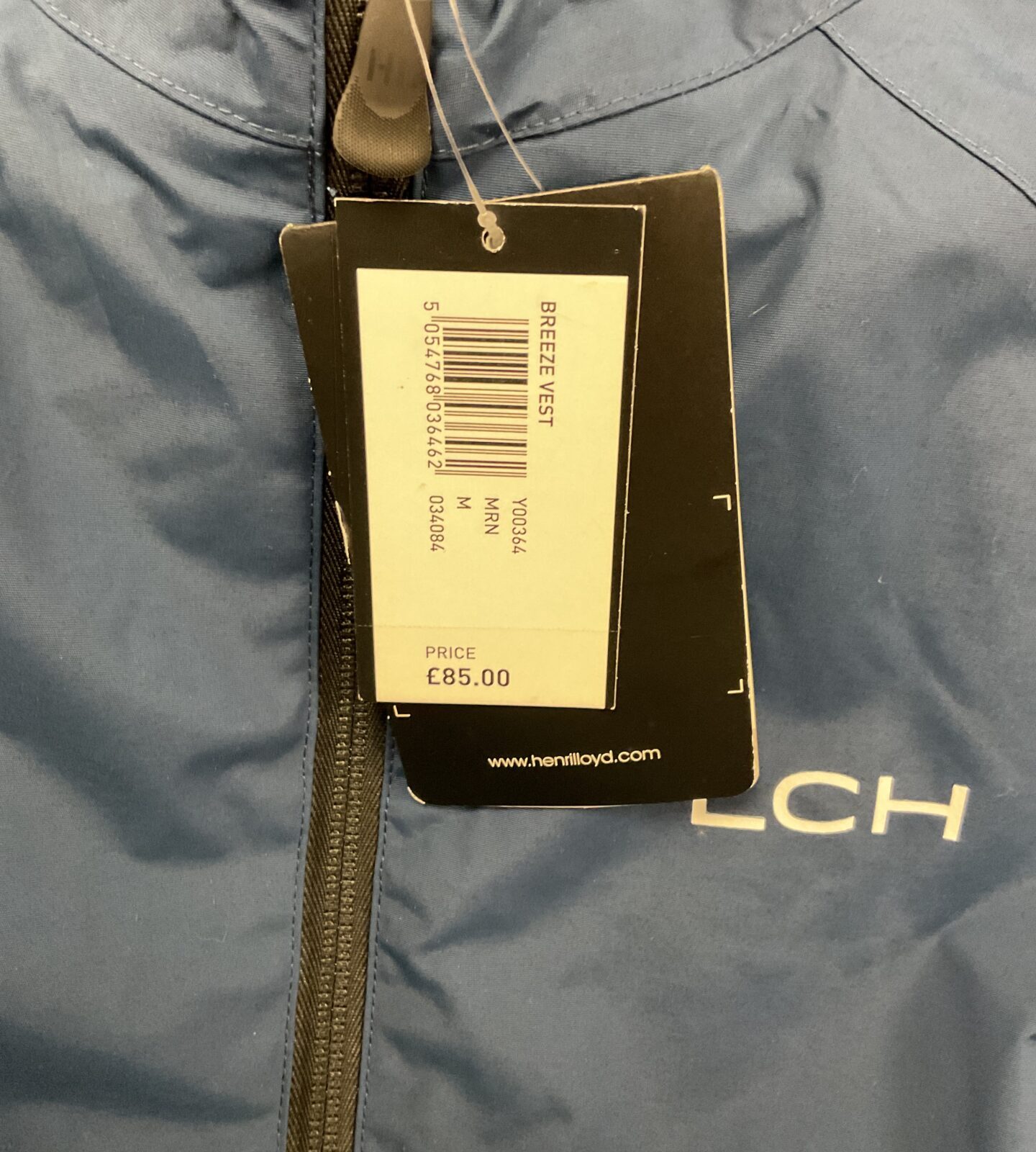 Close-up of Henri Lloyd Breeze Vest tag with model number.