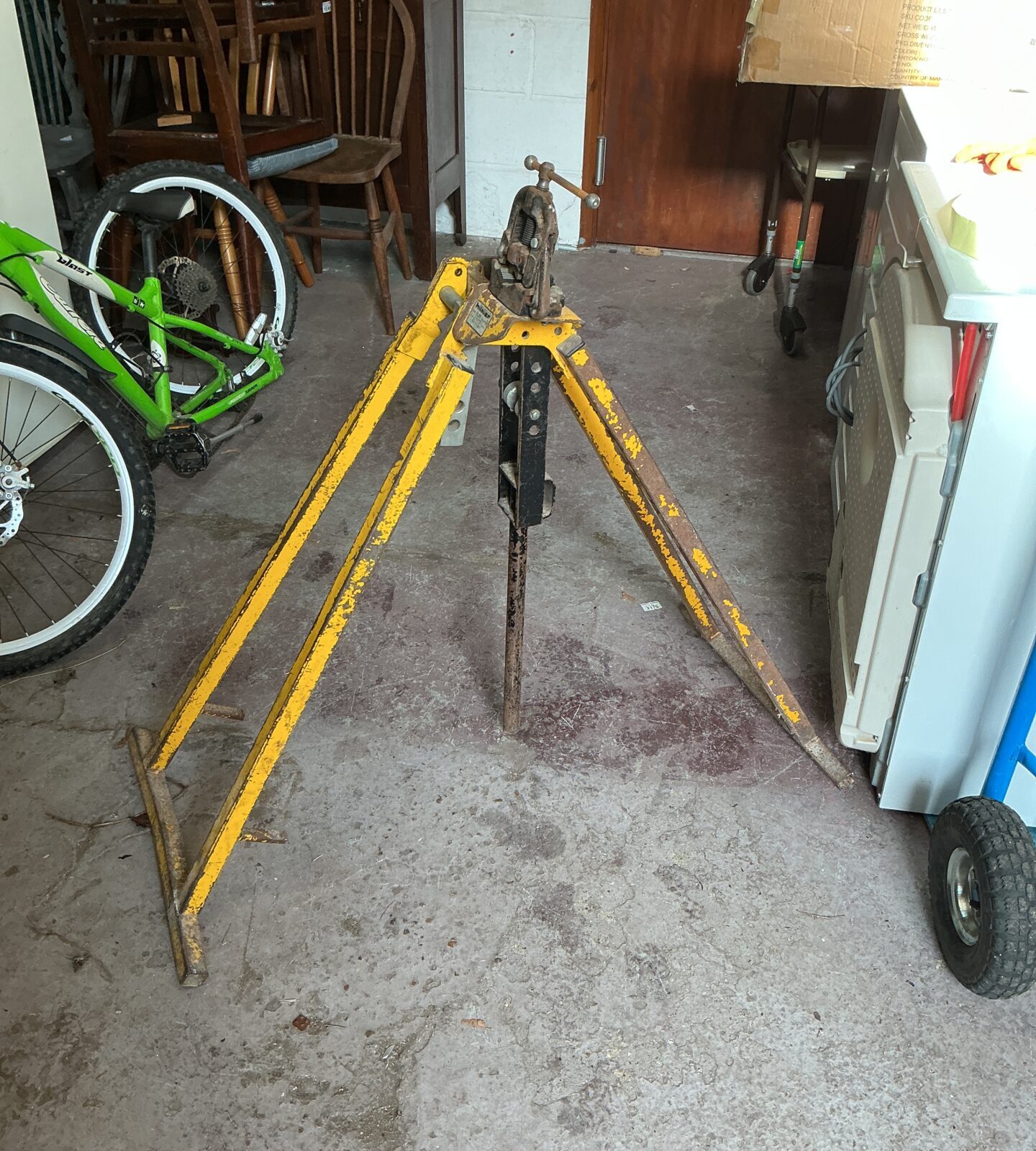 Yellow Hilmor pipe bending stand in a workshop setting.