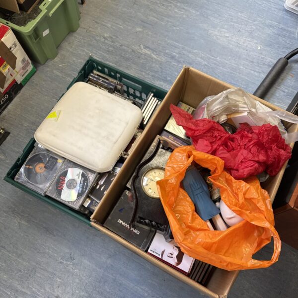 Mixed house clearance lot with boxes of CDs and ornaments.