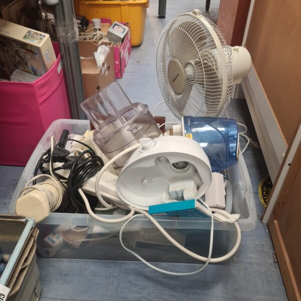 House clearance lot with kitchenware and a portable fan.