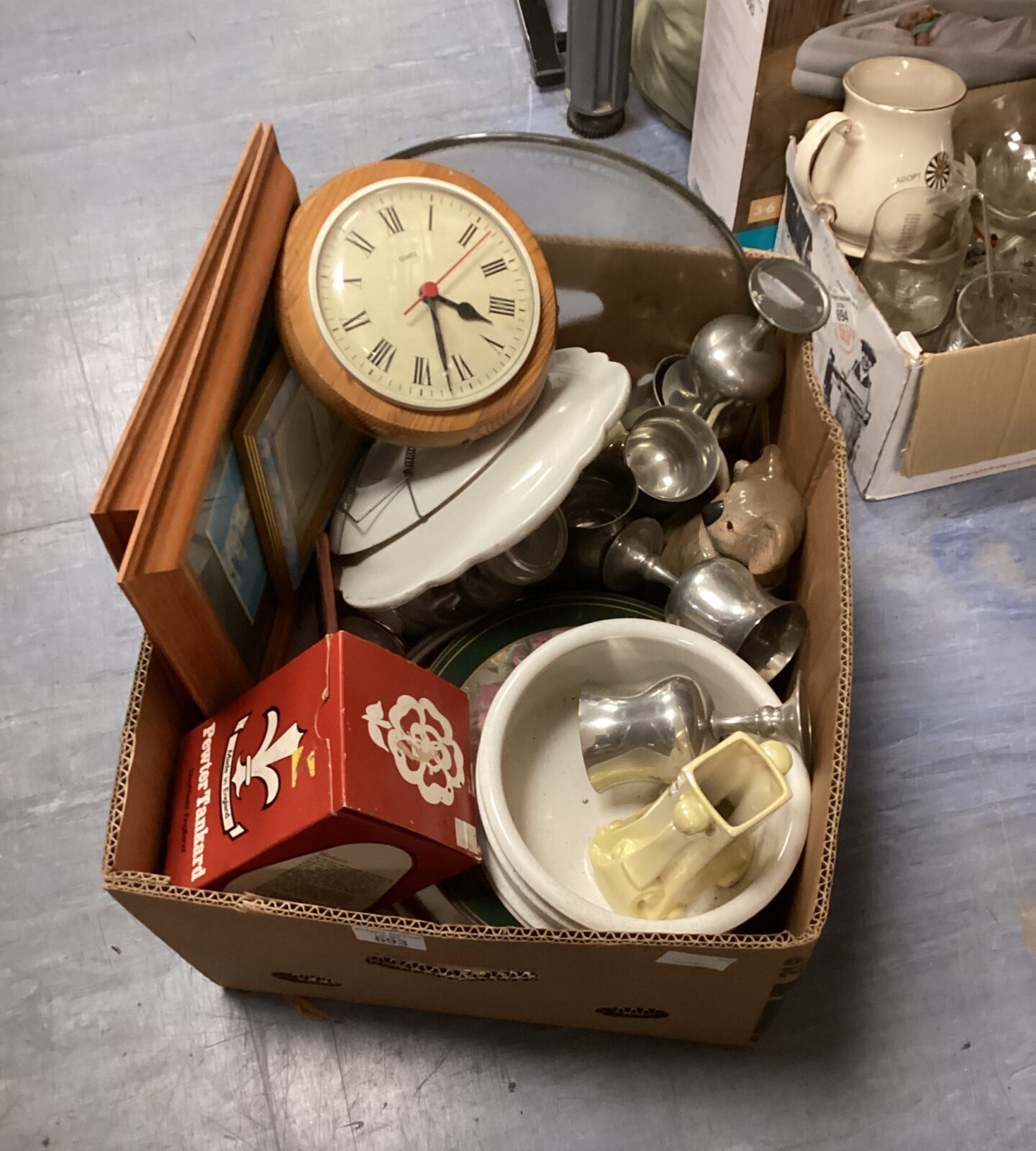 House clearance lot with pewter tankards and glassware on display.