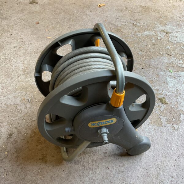 Durable Hozelock hose reel for garden hose storage.
