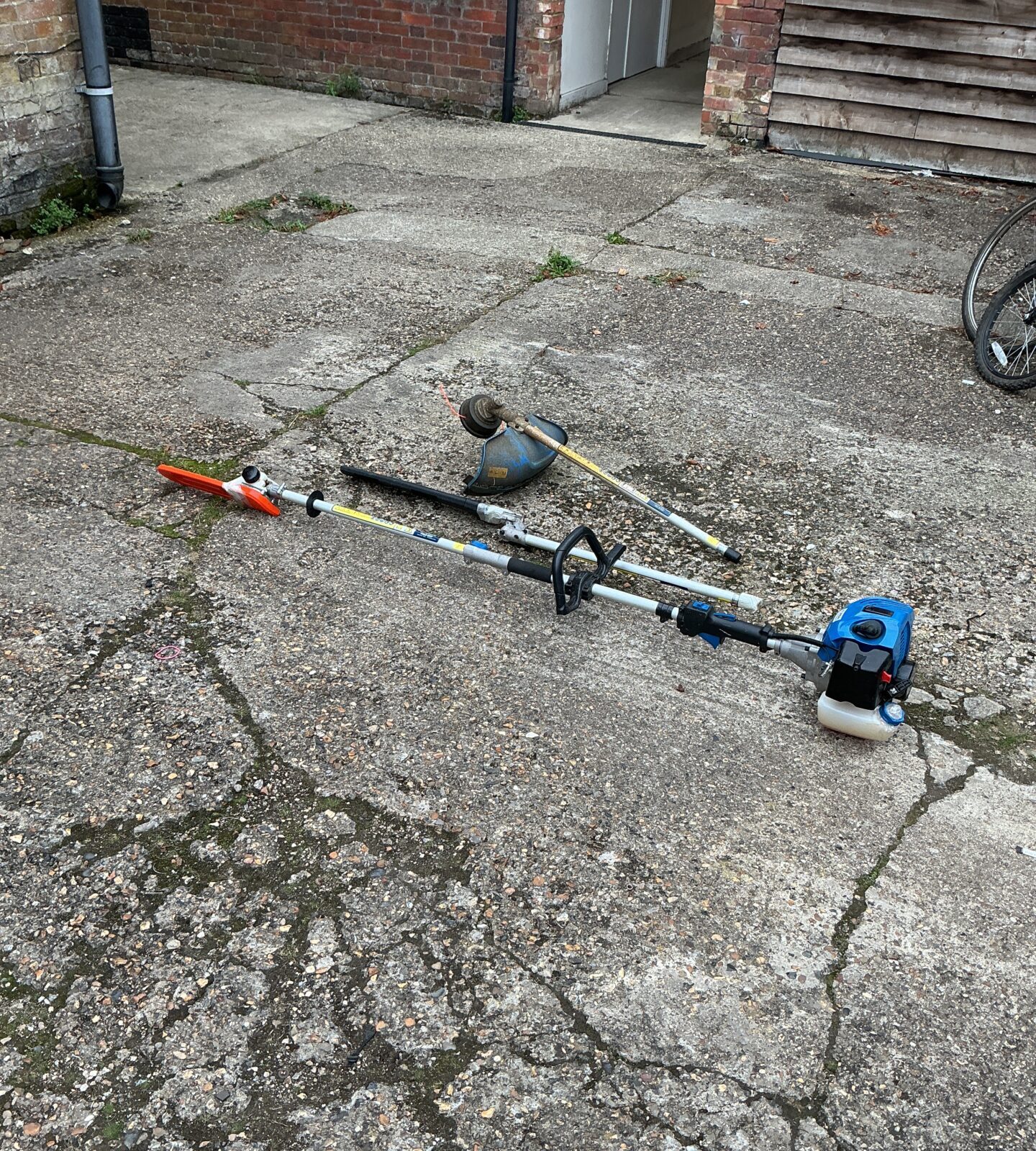 Hyundai petrol garden multi tool showing attachments.