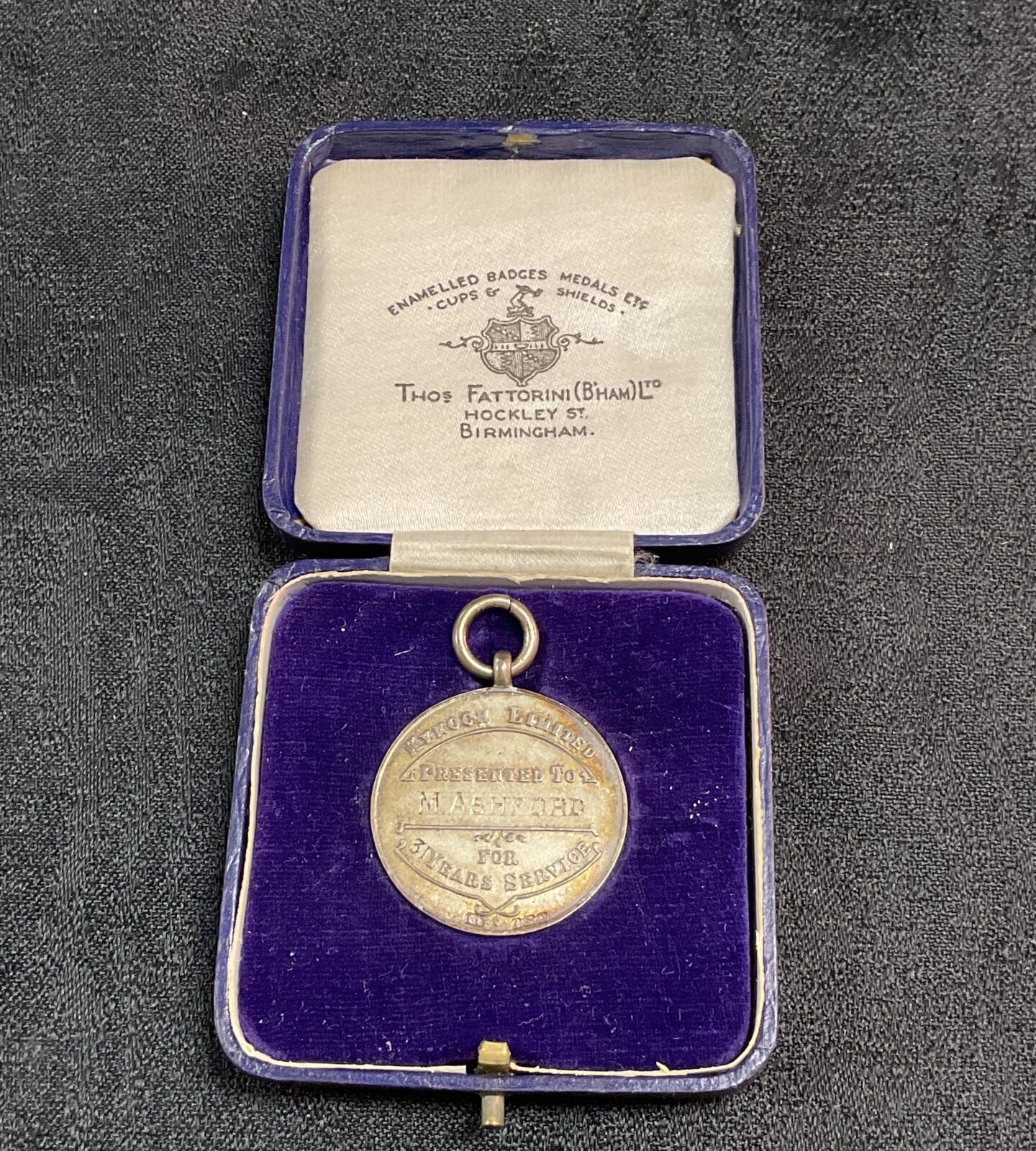 Open presentation case displaying ICI Kynoch medal.