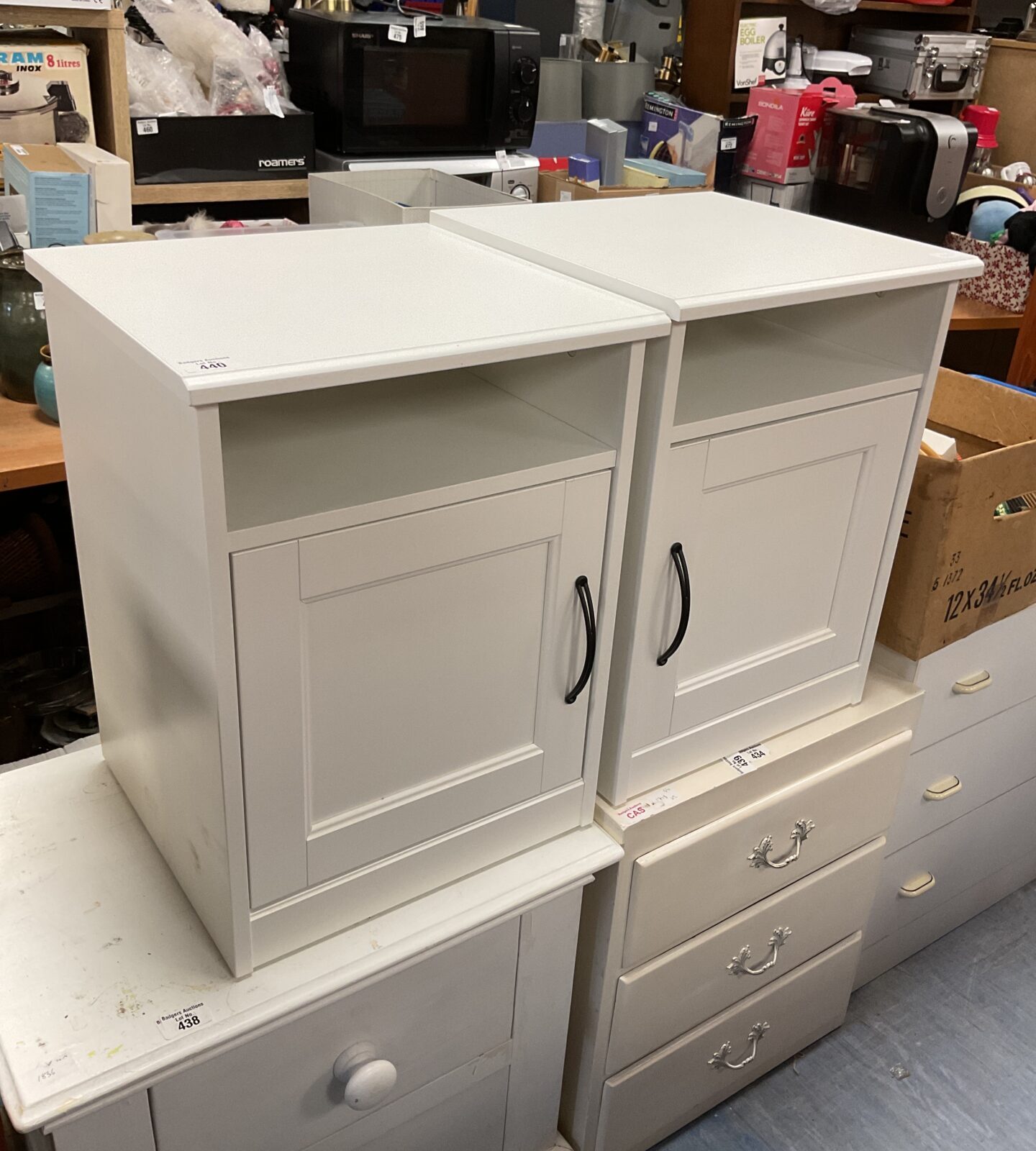 Two white Ikea bedside tables with a single drawer.
