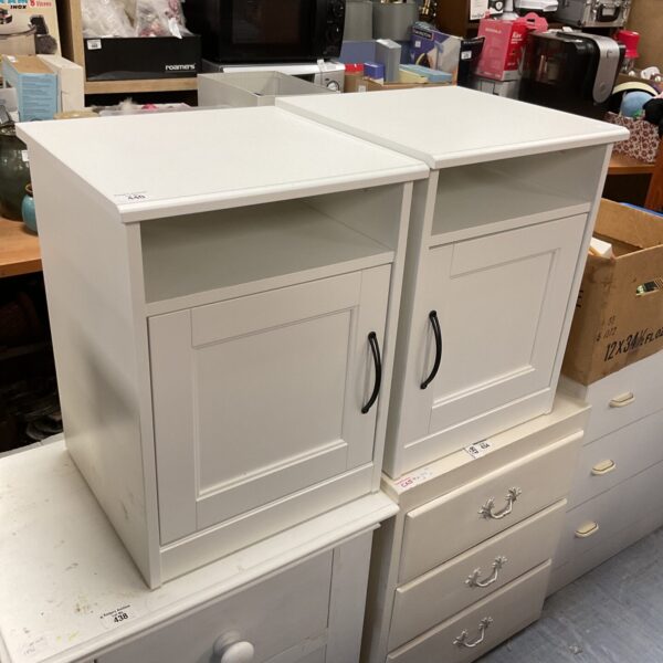Two white Ikea bedside tables with a single drawer.