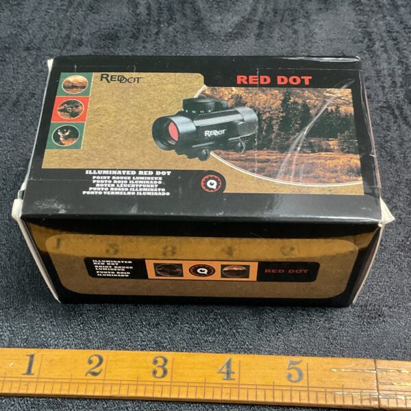 Sealed box of new illuminated red dot gun sight.