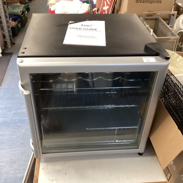 White Lec drinks fridge on a dark floor.