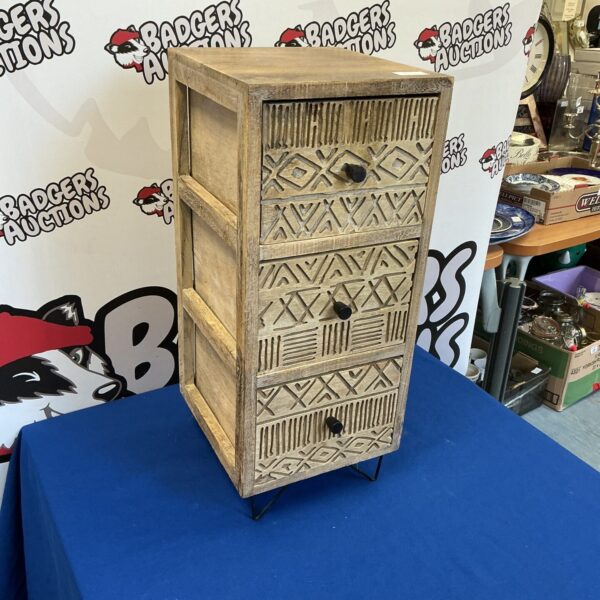 Small three-drawer textured chest with a rustic wood finish.