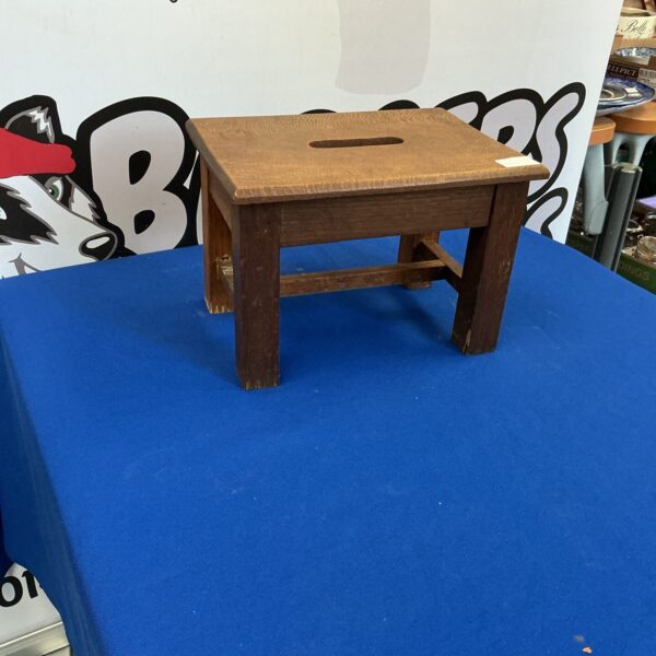 Vintage wooden foot stool with rustic farmhouse style.
