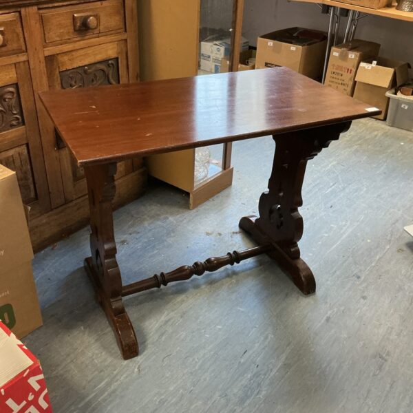 Vintage mahogany side table with carved legs and warm wood tone.