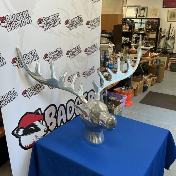 Detailed metal moose head sculpture for rustic wall decor.