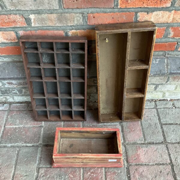 Set of three vintage wooden display boxes with compartments.