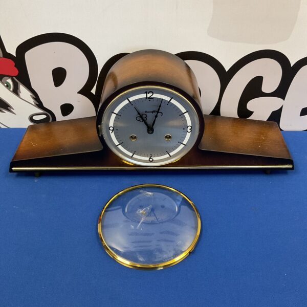 Vintage Hermle buffet clock with mahogany case on display.