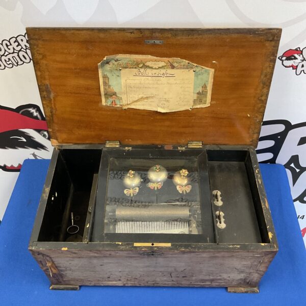 Antique Victorian music box with butterfly strikers needing restoration.