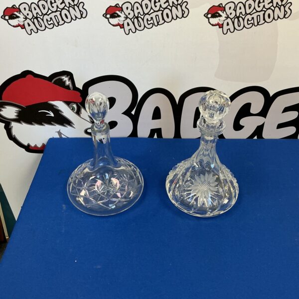 Pair of vintage crystal ship decanters, elegant glassware.