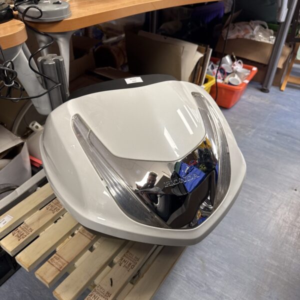 Side view of a grey Honda pillion box for motorcycle storage.