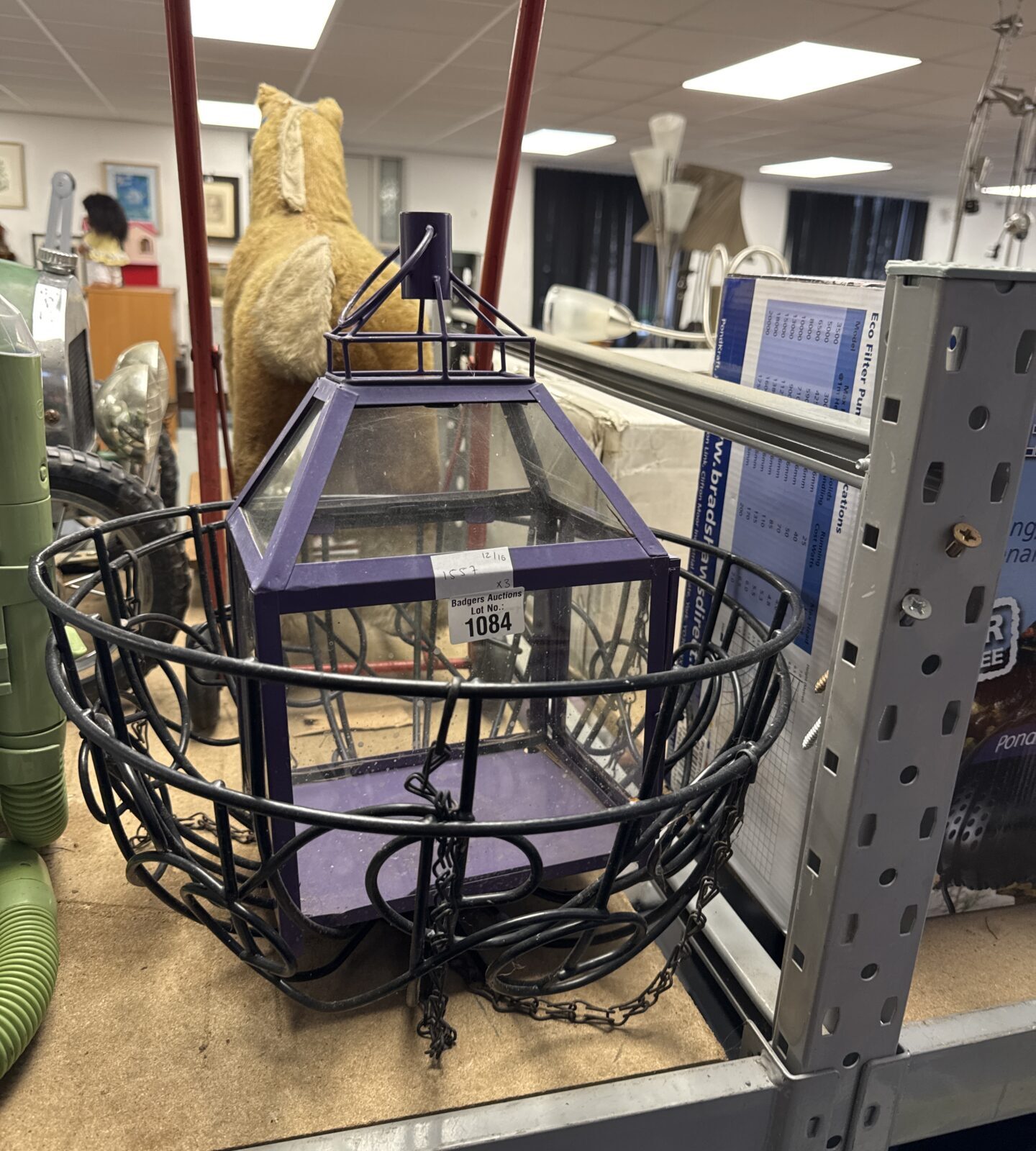 Two wire framed hanging baskets with a hanging lantern