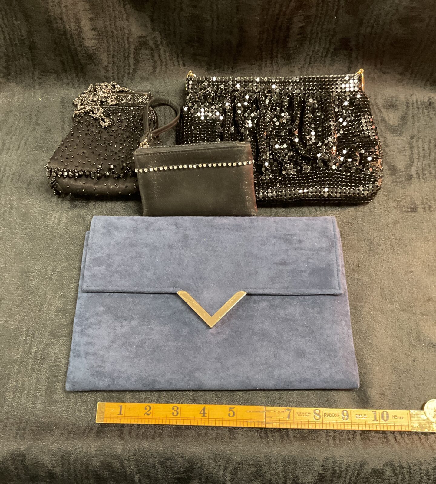 three black bead purses and blue clutch bag