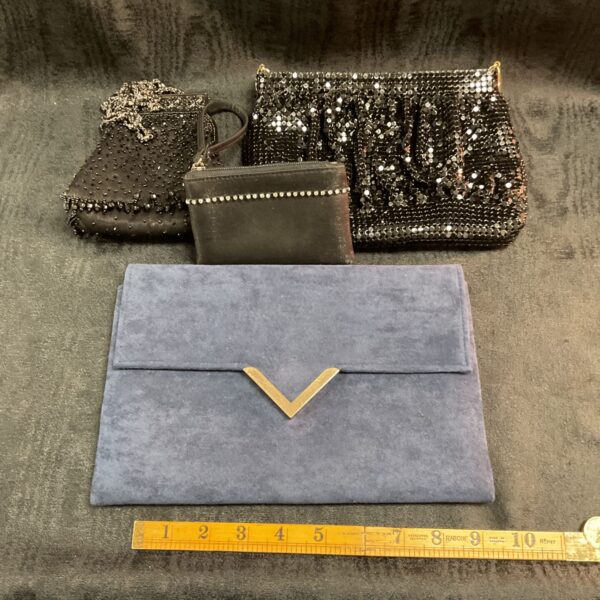 three black bead purses and blue clutch bag