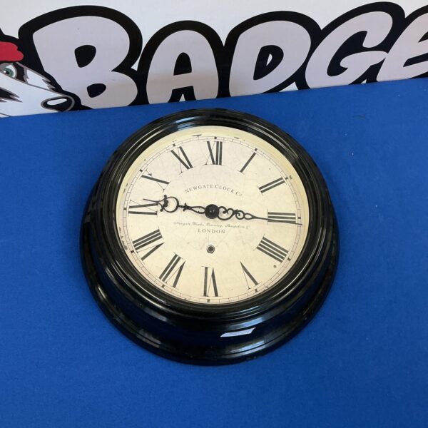 Vintage Newgate Clock Co wall clock with black numerals.