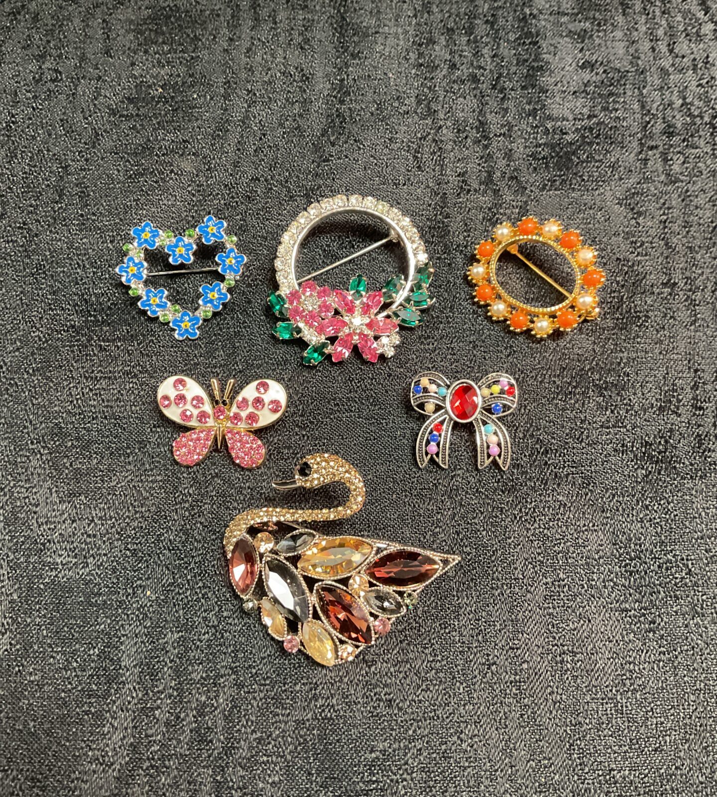 Six Multi colour jewelled brooches