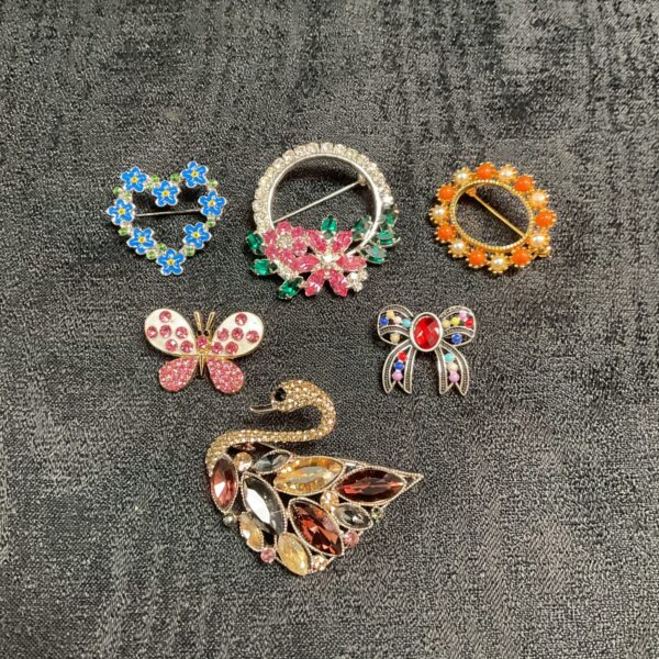 Six Multi colour jewelled brooches