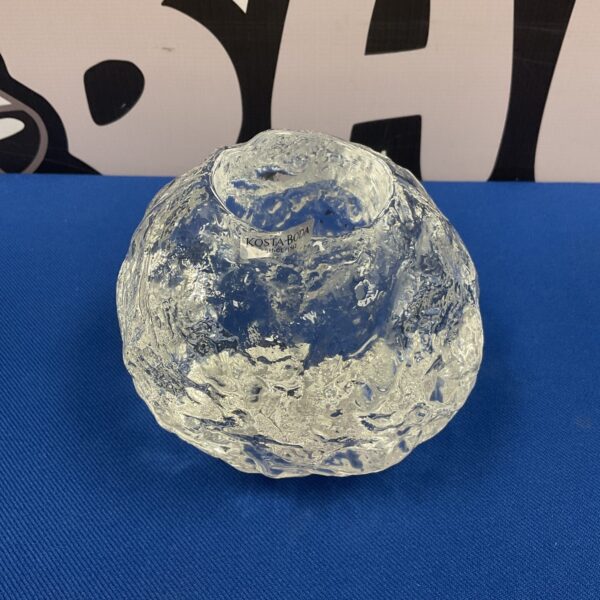 Clear glass Kosta Boda Snowball tealight holder for warm ambiance.
