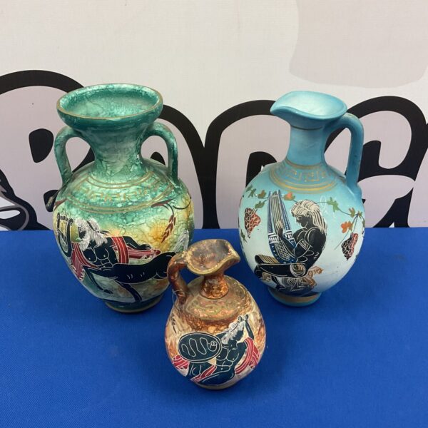 Three antique Greek pottery water vessels with mythological designs.