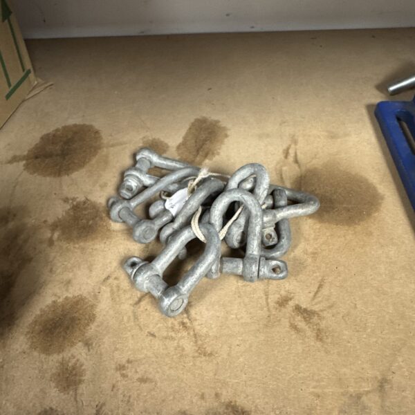 Bundle of small metal D shackles for rigging and lifting.