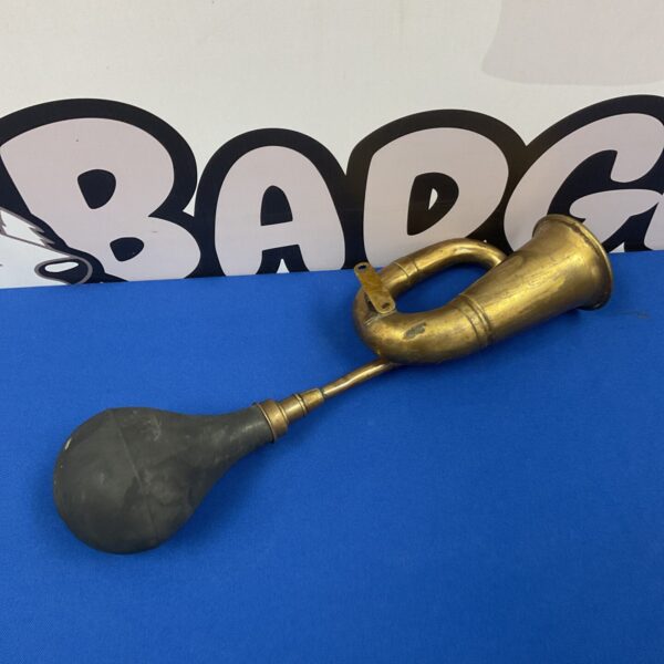 Vintage brass car horn with lever mechanism.