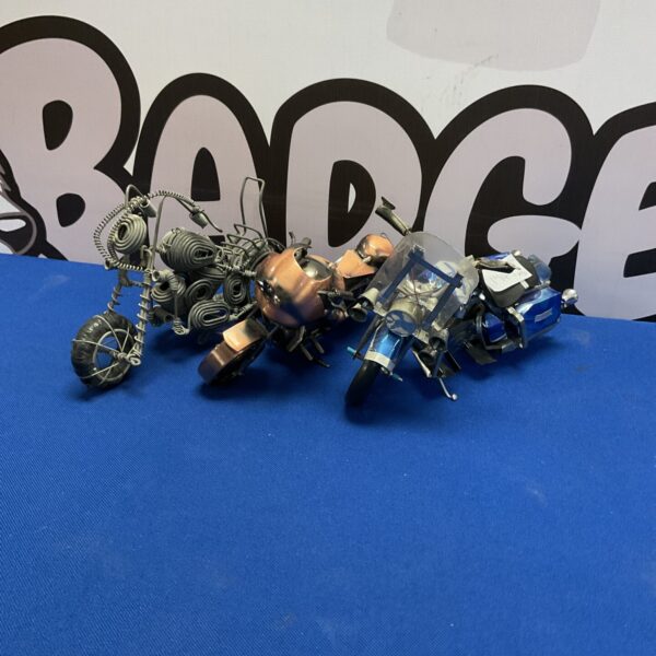 Detailed collection of three model motorcycles for collectors.