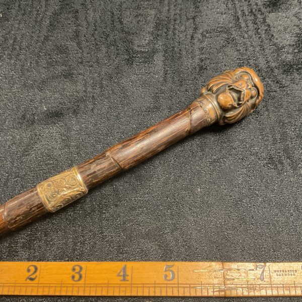 Full view of antique Victorian pepper spray cane with monkey head.
