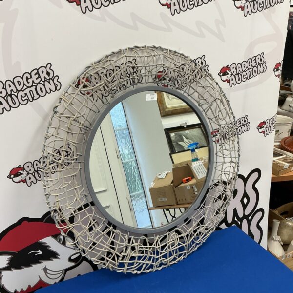 Rustic wire framed circular wall mirror for home decor.