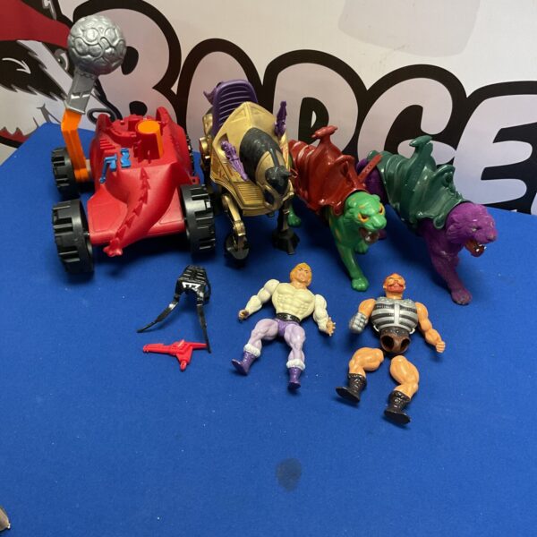 Vintage He-Man toys lot from the 1980s, including figures and vehicles.