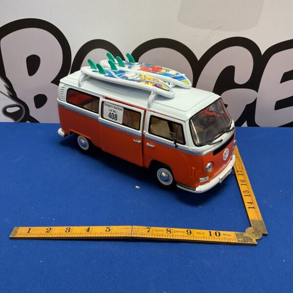 Vintage Dickie Toys VW Camper Van with surfboard on roof.