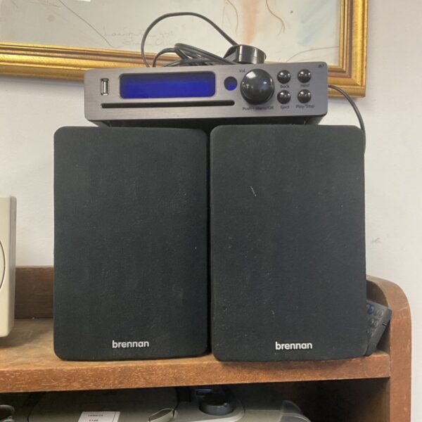 Brennan JB7 wireless music player with remote control and speakers.
