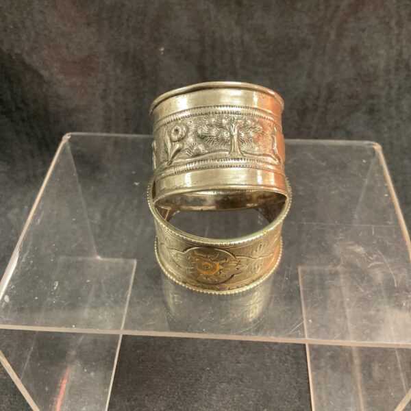 Vintage whitemetal napkin rings with floral embossed design.