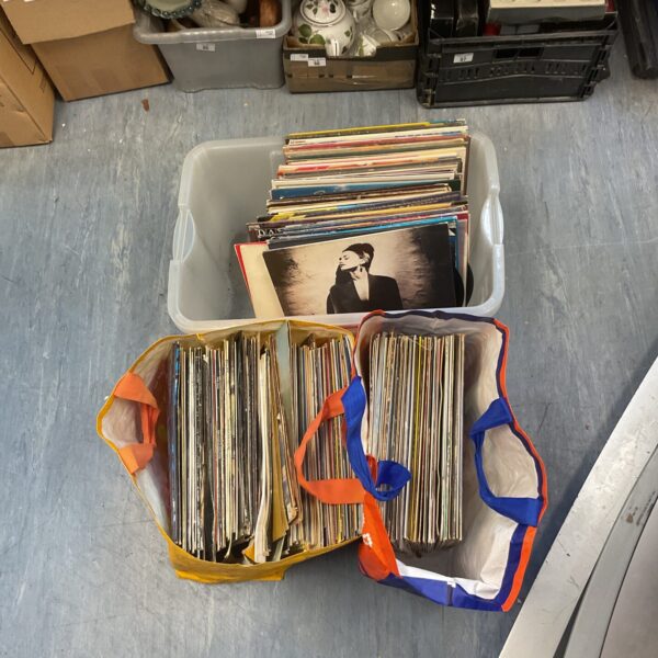 Large crate filled with a diverse vinyl records collection.