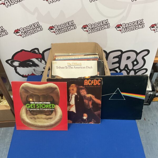 Collection of vintage rock vinyl records including AC/DC and Pink Floyd.