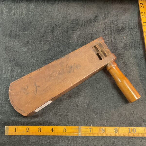 WWI trench gas rattle with inscription, side view.